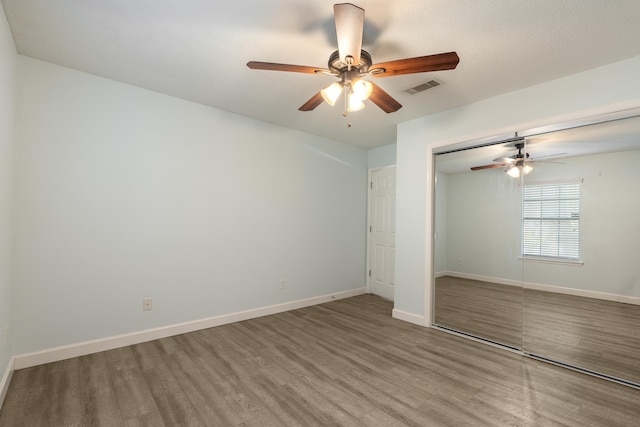 2214 Yaupon Dr, Tallahassee, FL 32303 - unfurnished bedroom with wood finished floors, a closet, and ceiling fan