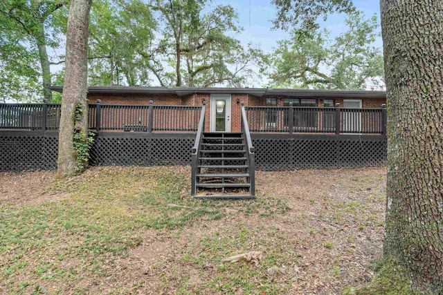 2214 Yaupon Dr, Tallahassee, FL 32303 - back of house with brick siding, a wooden deck, and stairway