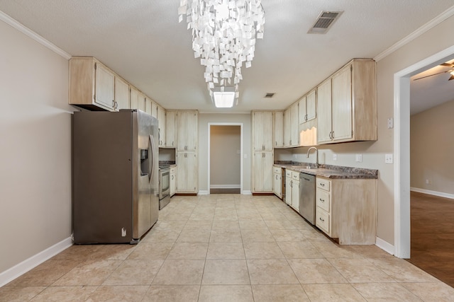 2214 Yaupon Dr, Tallahassee, FL 32303 - kitchen with appliances with stainless steel finishes, crown molding, light brown cabinets, dark countertops, and a chandelier