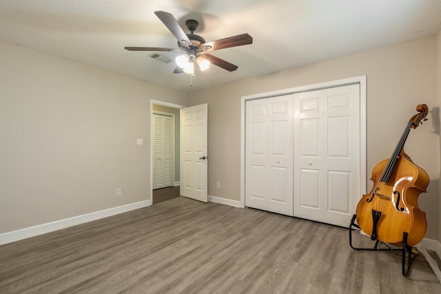 2214 Yaupon Dr, Tallahassee, FL 32303 - unfurnished bedroom with wood finished floors, a closet, and a ceiling fan