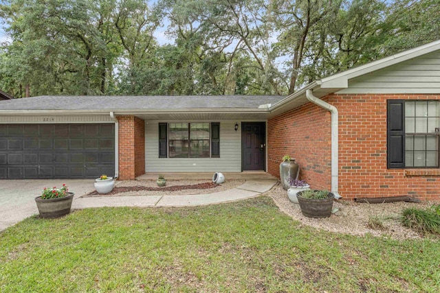 2214 Yaupon Dr, Tallahassee, FL 32303 - single story home featuring a garage, brick siding, concrete driveway, and a front lawn