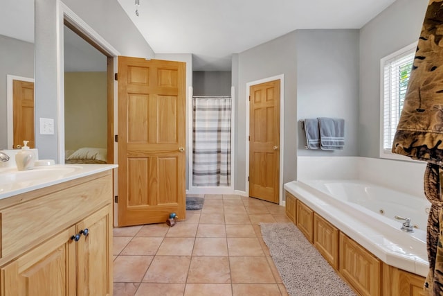 full bathroom with a jetted tub, vanity, a shower with shower curtain, and tile patterned flooring