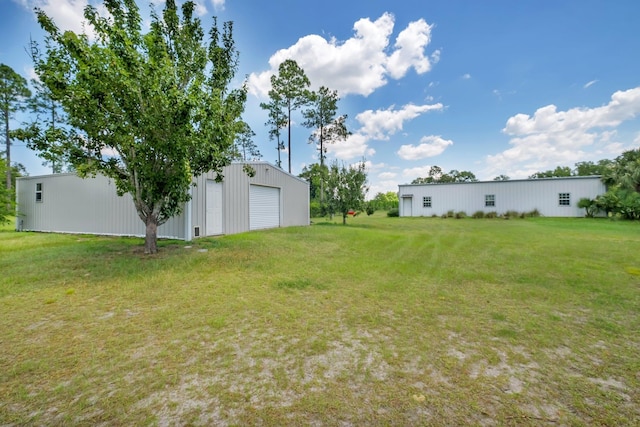 view of yard with an outbuilding, a garage, and an outdoor structure