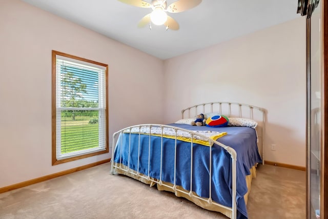 bedroom with baseboards, a ceiling fan, and carpet flooring