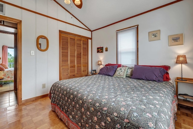 bedroom featuring light parquet floors, crown molding, lofted ceiling, and a closet