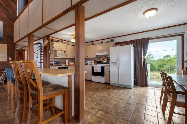 kitchen with crown molding, white appliances, ceiling fan, cream cabinets, and a textured ceiling