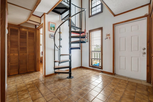 tiled foyer entrance featuring a textured ceiling