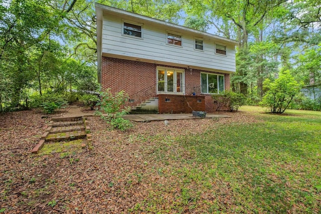 2003 Holly St, Tallahassee, FL 32303 - rear view of property featuring brick siding and a yard
