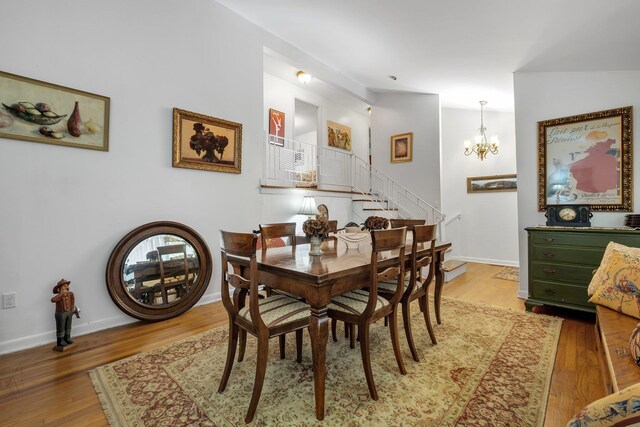 2003 Holly St, Tallahassee, FL 32303 - dining room with light wood-type flooring, a chandelier, stairway, and lofted ceiling