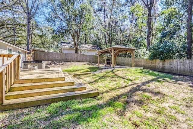 view of yard featuring a fenced backyard, a deck, and a gazebo