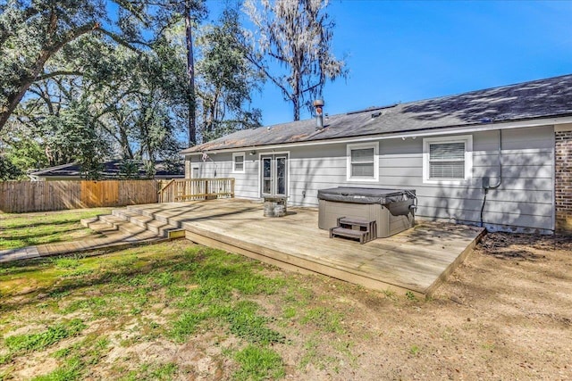 rear view of house with french doors, a yard, a hot tub, fence, and a wooden deck