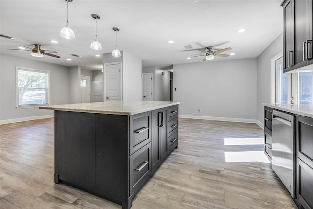 kitchen featuring light wood-style flooring, recessed lighting, a kitchen island, baseboards, and dishwasher