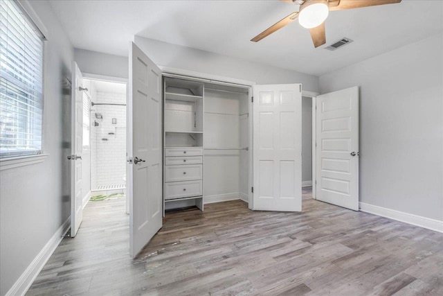 unfurnished bedroom featuring light wood-style floors, baseboards, visible vents, and a closet