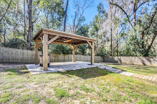 view of yard featuring a patio area, a fenced backyard, and a gazebo