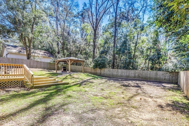 view of yard with a deck, a gazebo, and a fenced backyard