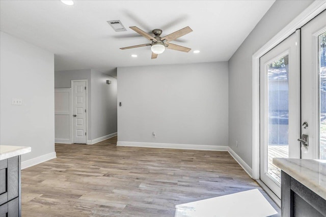 unfurnished room with visible vents, baseboards, a ceiling fan, light wood-style flooring, and recessed lighting