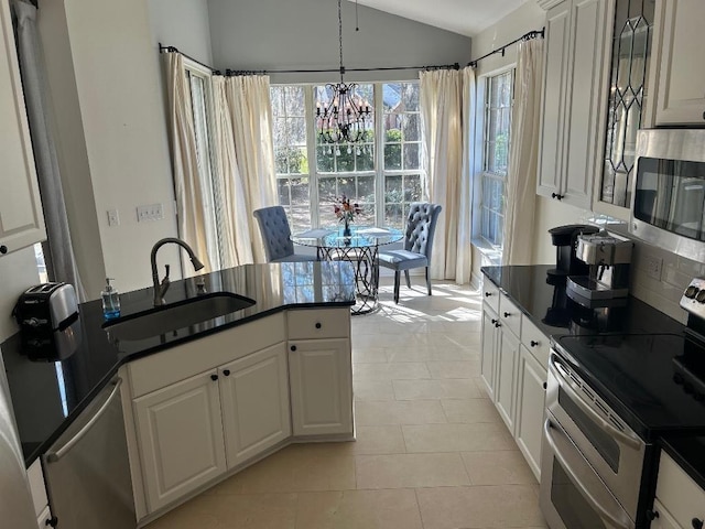 kitchen featuring a sink, dark countertops, and stainless steel appliances