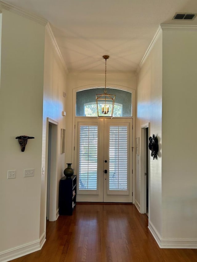 foyer entrance with visible vents, dark wood-style flooring, french doors, crown molding, and a notable chandelier