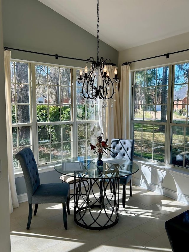 dining area featuring vaulted ceiling and a notable chandelier