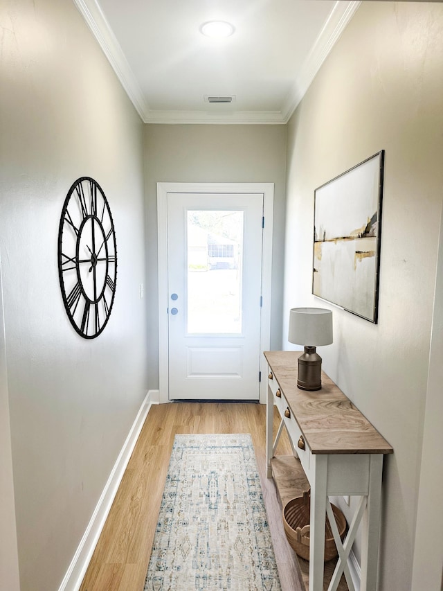 doorway to outside featuring light hardwood / wood-style floors and ornamental molding