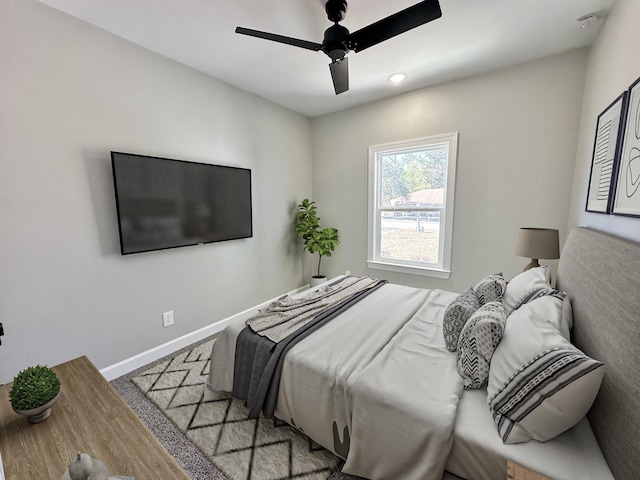 bedroom featuring ceiling fan and light carpet