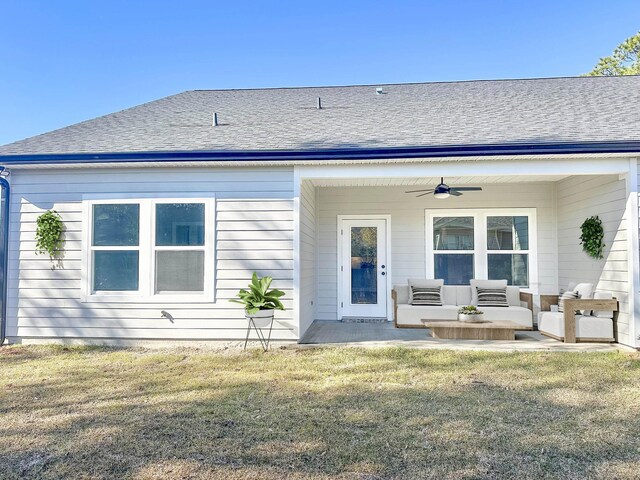 back of property featuring outdoor lounge area, ceiling fan, a yard, and a patio