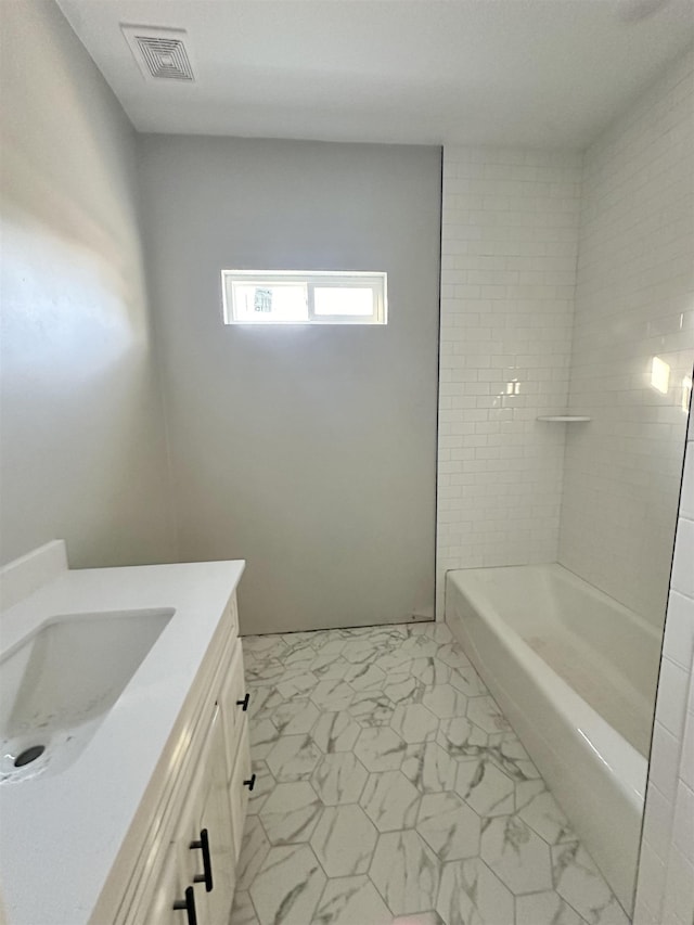 bathroom featuring vanity and shower / bath combination