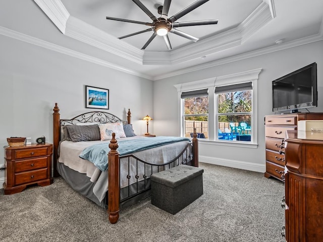 carpeted bedroom featuring crown molding, a raised ceiling, and ceiling fan