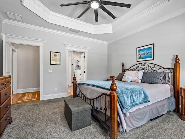 carpeted bedroom featuring ornamental molding, ceiling fan, and a tray ceiling