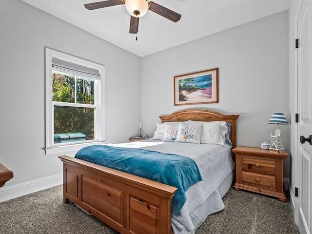 bedroom with ceiling fan and dark colored carpet