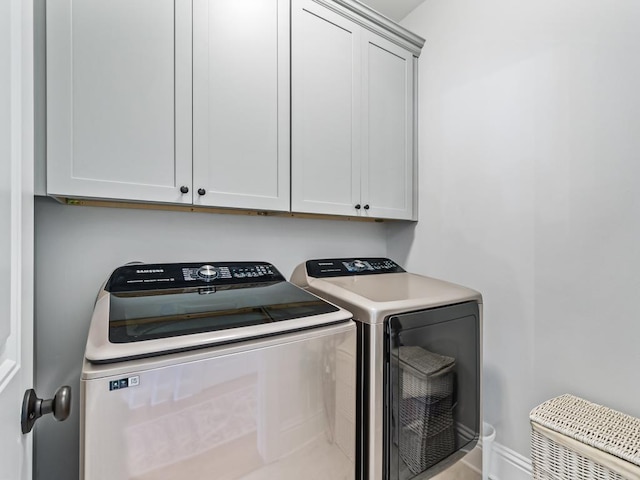 laundry room with cabinets and separate washer and dryer