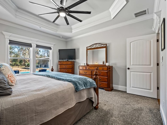 bedroom featuring ornamental molding, carpet flooring, ceiling fan, and a tray ceiling