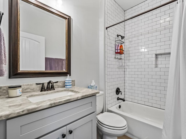 full bathroom with vanity, shower / tub combo, and toilet