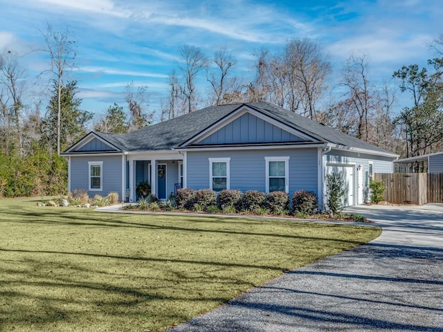 ranch-style house with a garage and a front yard