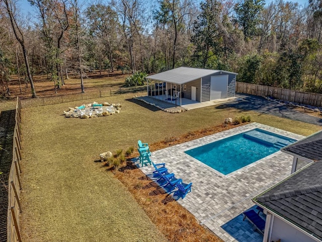 view of pool with a patio, a yard, and an outbuilding