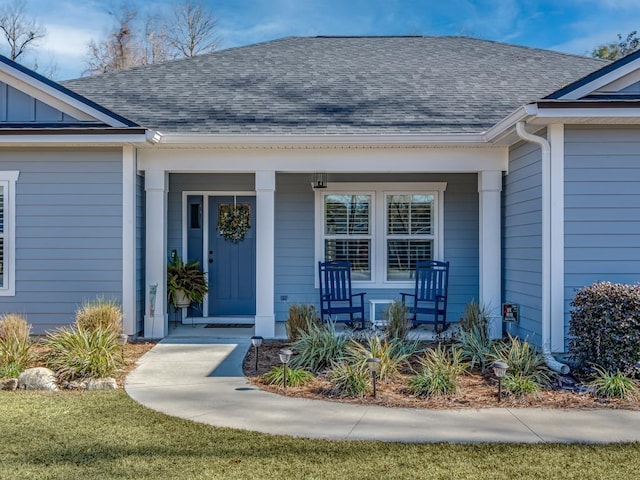 view of exterior entry with covered porch