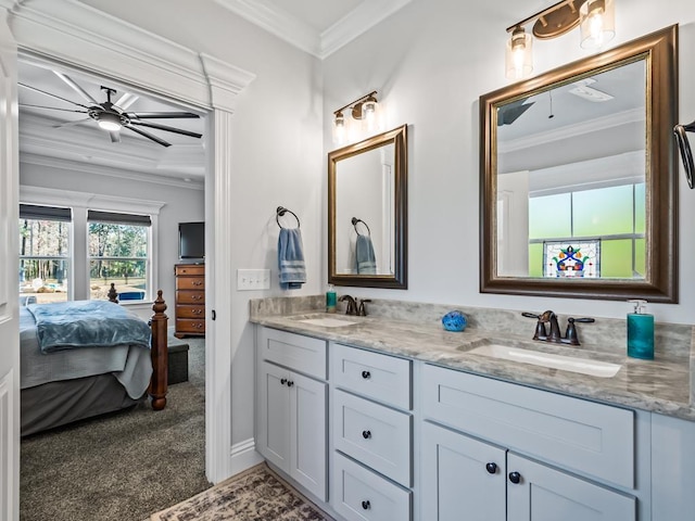 bathroom with ceiling fan, ornamental molding, and vanity