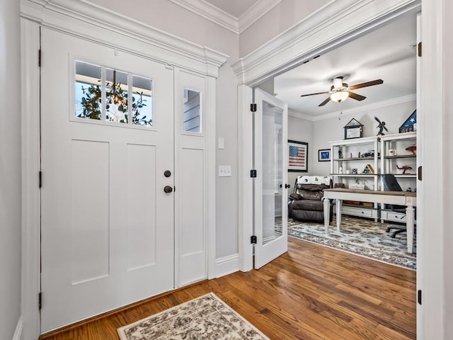 entrance foyer featuring wood-type flooring, ornamental molding, and ceiling fan