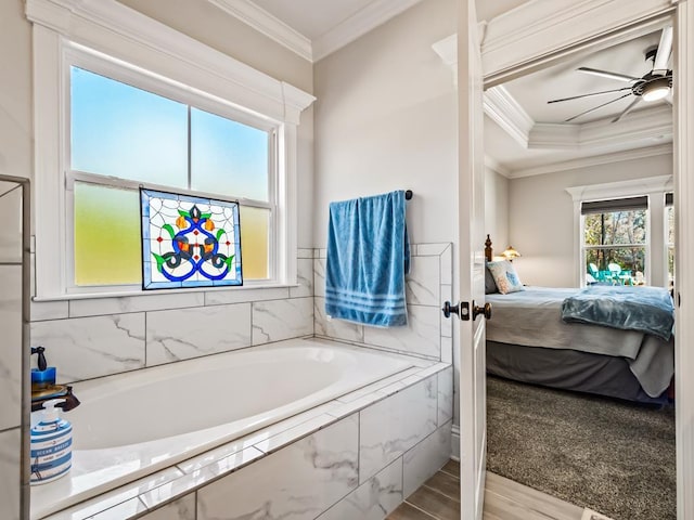 bathroom featuring hardwood / wood-style flooring, ceiling fan, ornamental molding, and tiled tub