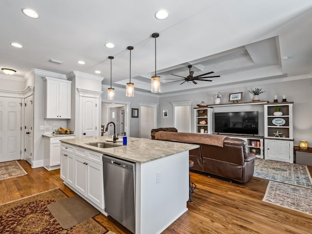 kitchen featuring dishwasher, a raised ceiling, and white cabinets