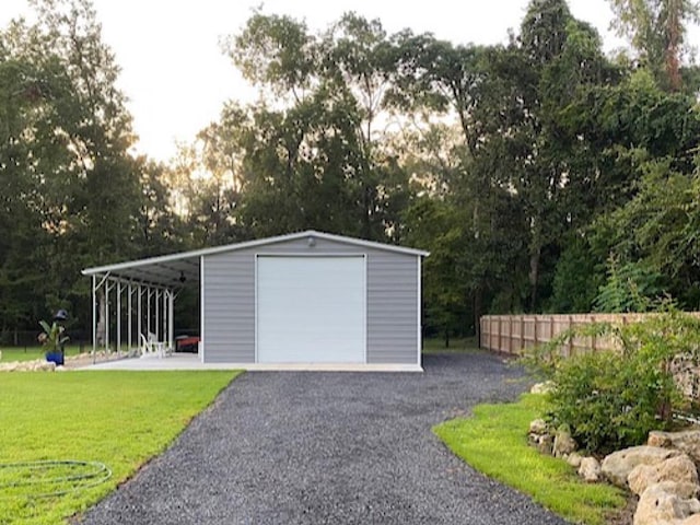 garage featuring a yard and a carport