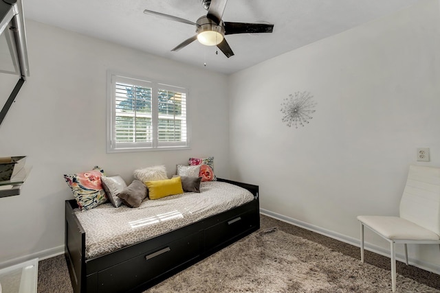 bedroom with ceiling fan, baseboards, and carpet flooring