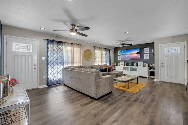 living area with recessed lighting, dark wood finished floors, and baseboards