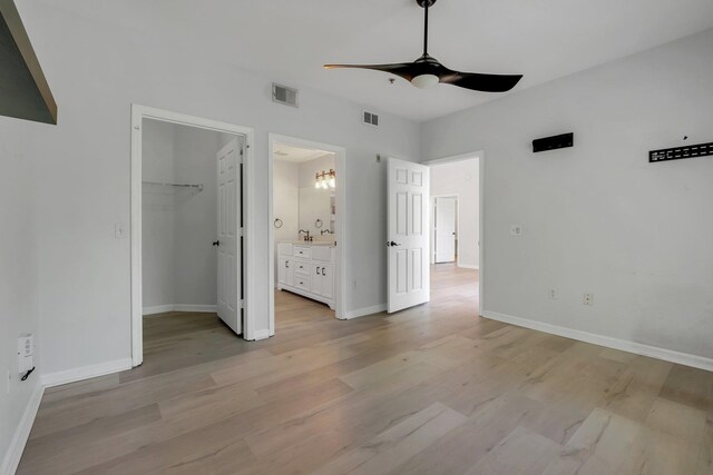 2801 Chancellorsville Dr Unit 236, Tallahassee, FL 32312 - unfurnished bedroom with baseboards, light wood-style flooring, a spacious closet, and connected bathroom
