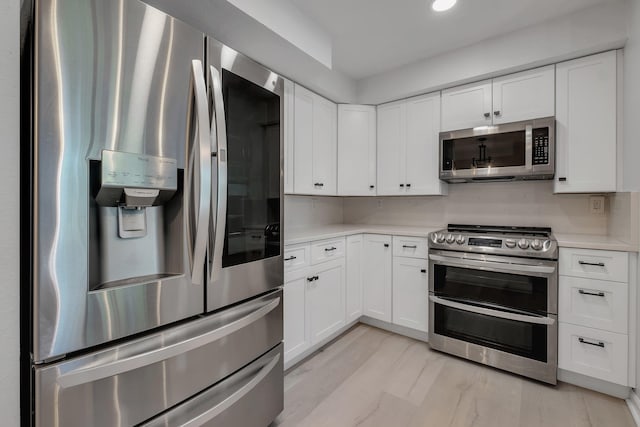 2801 Chancellorsville Dr Unit 236, Tallahassee, FL 32312 - kitchen featuring stainless steel appliances, light countertops, white cabinets, recessed lighting, and light wood-type flooring