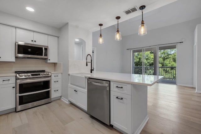 2801 Chancellorsville Dr Unit 236, Tallahassee, FL 32312 - kitchen featuring appliances with stainless steel finishes, a sink, a peninsula, light countertops, and recessed lighting