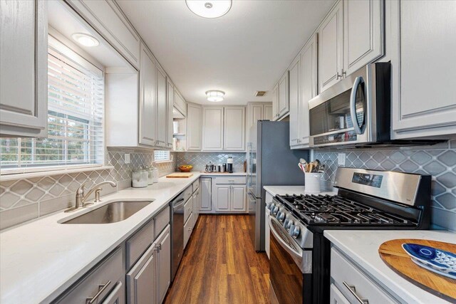 40 Carrol Dr, Crawfordville, FL 32327 - kitchen with stainless steel appliances, a sink, dark wood-type flooring, decorative backsplash, and light countertops
