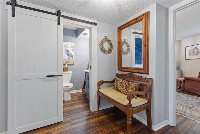40 Carrol Dr, Crawfordville, FL 32327 - bathroom featuring toilet, wood finished floors, baseboards, vanity, and a textured ceiling