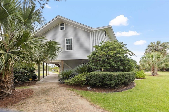 40 Carrol Dr, Crawfordville, FL 32327 - view of home's exterior with a carport, dirt driveway, and a lawn