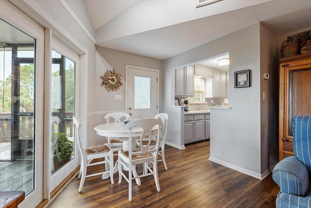 40 Carrol Dr, Crawfordville, FL 32327 - dining area with dark wood finished floors, baseboards, and lofted ceiling